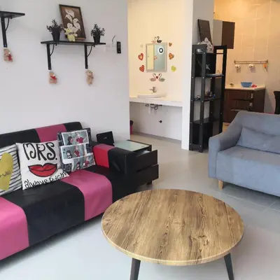 a living room with a couch and a table at Lily Homestay Barrington Square Cameron Highlands. in Brinchang
