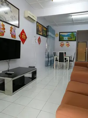 a living room with a tv and a couch and a table at YITOM Homestay\u6613\u901a\u6c11\u5bbf in Sungai Besar