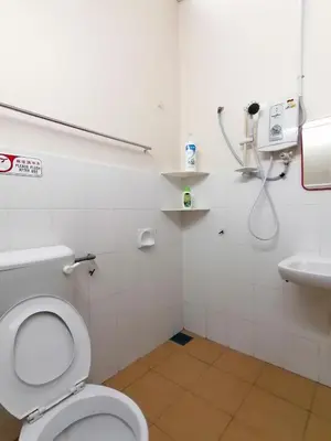 a bathroom with a toilet and a sink at YITOM Homestay\u6613\u901a\u6c11\u5bbf in Sungai Besar