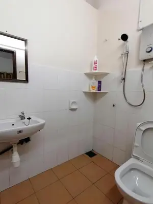 a bathroom with a sink and a toilet at YITOM Homestay\u6613\u901a\u6c11\u5bbf in Sungai Besar