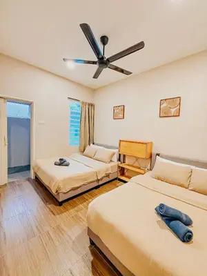 a bedroom with two beds and a ceiling fan at Golden Sweet Home @ Golden Hills (Night Market, \u591c\u5e02) in Tanah Rata