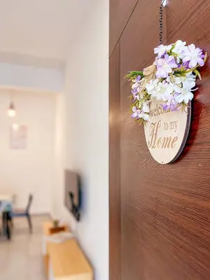 a door with a welcome sign on it with flowers at Golden Sweet Home @ Golden Hills (Night Market, \u591c\u5e02) in Tanah Rata