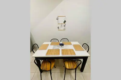 a dining room with a table and chairs at LILY VACATION HOME at CAMERON HIGHLANDS - 12 PAX,FREE WiFi w CARPORCH in Tanah Rata