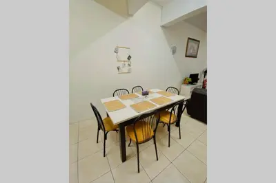 a dining room with a table and chairs at LILY VACATION HOME at CAMERON HIGHLANDS - 12 PAX,FREE WiFi w CARPORCH in Tanah Rata
