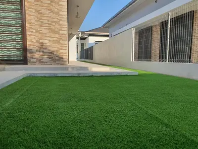 a yard of green grass in front of a house at Homestay D'Bertam, Kepala Batas, Penang, Muslim Saja in Kepala Batas