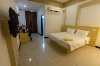 a bedroom with a bed and a television in it at Scott Service Suites in George Town