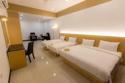 a hotel room with two beds and a desk at Scott Service Suites in George Town