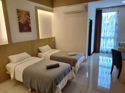 a hotel room with two beds and a window at Scott Service Suites in George Town