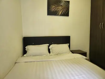 a bedroom with a bed with two pillows on it at Relax Bear Homestay in Tanah Rata