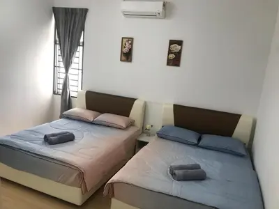 two beds sitting next to each other in a bedroom at Taiping Rain Town Homestay\u592a\u5e73\u96e8\u57ce\u540d\u5bbf two car park in Taiping