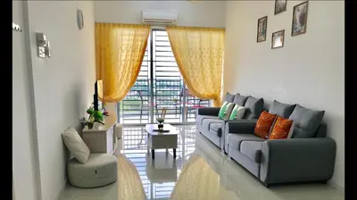 a living room with a gray couch and a chair at Taiping Rain Town Homestay\u592a\u5e73\u96e8\u57ce\u540d\u5bbf two car park in Taiping