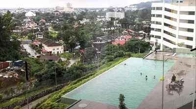 a swimming pool in the middle of a city at Taiping Rain Town Homestay\u592a\u5e73\u96e8\u57ce\u540d\u5bbf two car park in Taiping