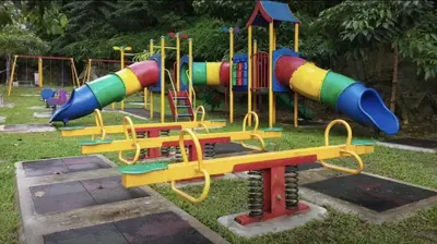 a playground with a colorful slide in the grass at Taiping Rain Town Homestay\u592a\u5e73\u96e8\u57ce\u540d\u5bbf two car park in Taiping