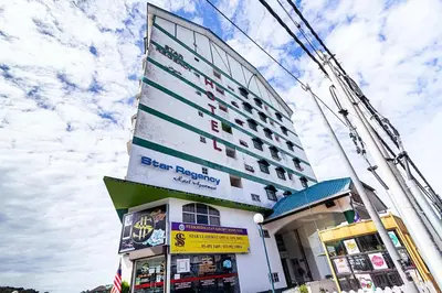 a tall building with a store in front of it at Amy Home Moonlight Apartment, Cameron Highlands in Brinchang