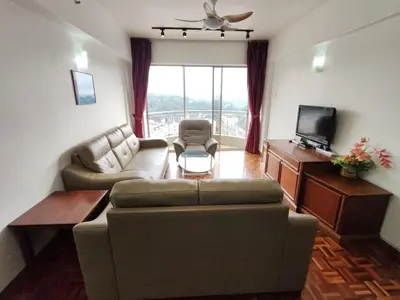 a living room with a couch and a tv at Amy Home Moonlight Apartment, Cameron Highlands in Brinchang