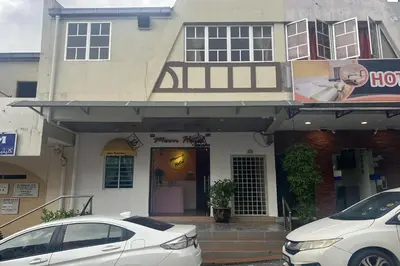 a white car parked in front of a building at Moon Hotel, Cameron Highlands in Brinchang