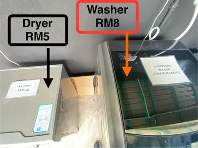 a box with a sign that says water rmb and a washing machine at Sacha Homestay in Baling