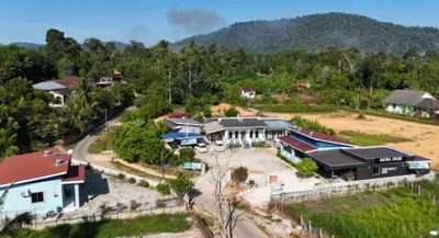 an aerial view of a house in a village at Sacha Homestay in Baling