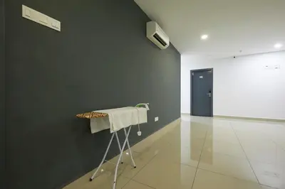 a room with a green wall and a towel on a rack at East Sun Hotel Sekinchan in Sekincan