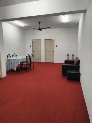 a room with a table and chairs and a red carpet at WORLD KIDS FANTASY in Lumut