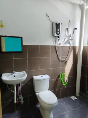 a bathroom with a toilet and a sink at WORLD KIDS FANTASY in Lumut