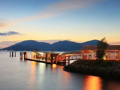 a bridge over a body of water at sunset at WORLD KIDS FANTASY in Lumut