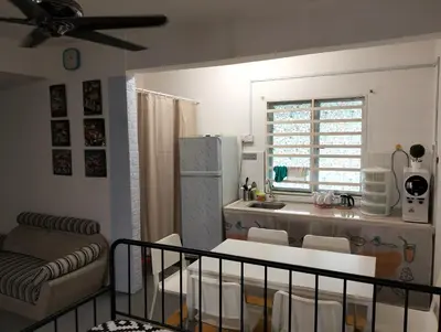a kitchen with a table and chairs in a room at lost world of tambun homestay in Ipoh