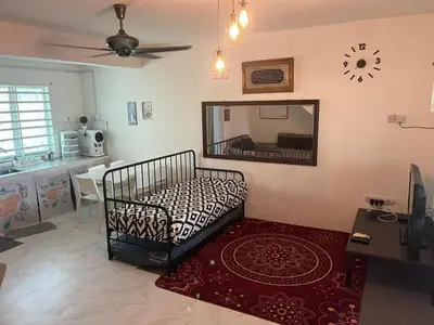 a bedroom with a bed and a mirror on the wall at lost world of tambun homestay in Ipoh