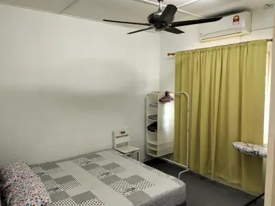 a bedroom with a bed and a ceiling fan at lost world of tambun homestay in Ipoh