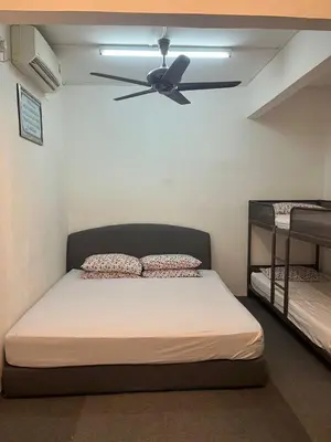 a bedroom with a bed and a ceiling fan at lost world of tambun homestay in Ipoh