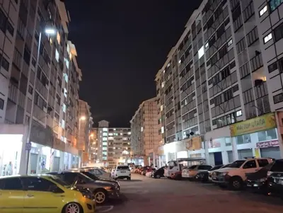 a city street at night with cars parked at Fizan Homestay in Tanah Rata