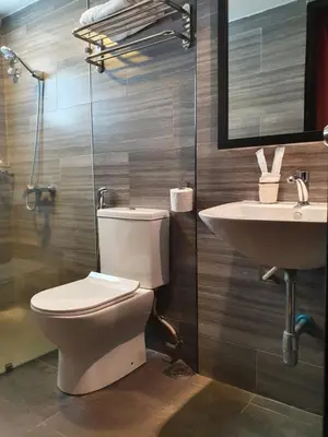 a bathroom with a toilet and a sink at See Foo Hotel in Bidur