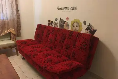 a red couch in a living room with at Tambun homestay in Ipoh