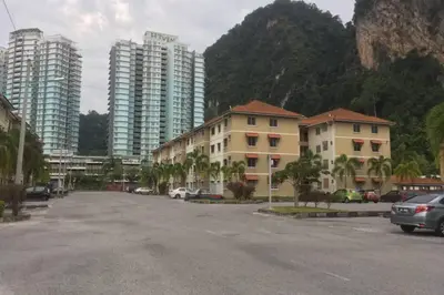 a parking lot in a city with tall buildings at Tambun homestay in Ipoh