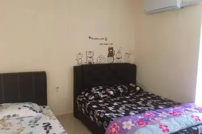 a bedroom with a bed and a comforter at Tambun homestay in Ipoh