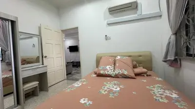 a small bedroom with a bed and a mirror at Taman Bagan Single Storey Terrace House, 9mins to Sunway Carnival Mall, Seberang Jaya in Butterworth