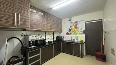 a kitchen with brown cabinets and a black counter top at Taman Bagan Single Storey Terrace House, 9mins to Sunway Carnival Mall, Seberang Jaya in Butterworth