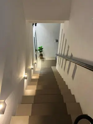 a stairway with a potted plant on the top of it at As Syifaa Homestay Mslim only in Ipoh