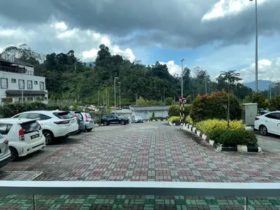a parking lot with many cars parked in it at The Quintet Cameron Highlands by Tulip in Tanah Rata