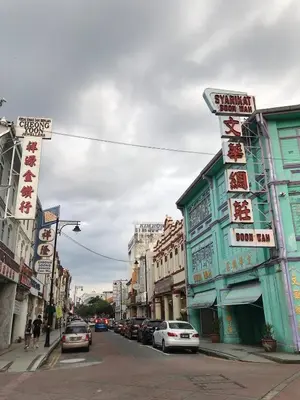 a city street with cars parked on the street at We Love GuestHouse in George Town