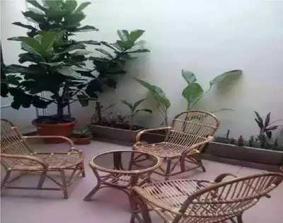 a group of chairs and a table and some plants at We Love GuestHouse in George Town