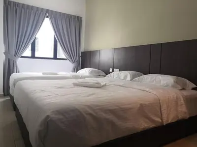 a large bed with two white pillows on it at Pangkor Happy Villa @ 88 Resort Villa Riadah in Kampong Sungai Udang