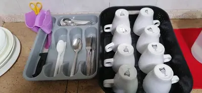 a plastic container filled with utensils and silverware at Unicorn Homestay @ Cameron Highland in Tanah Rata