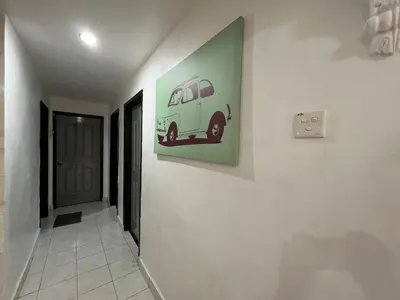 a hallway with a painting of a van on the wall at Unicorn Homestay @ Cameron Highland in Tanah Rata