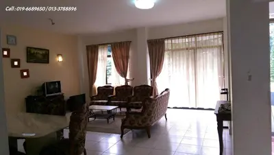 a living room with a table and chairs and windows at Ar Rayyan Apartments Prima Villa in Tanah Rata