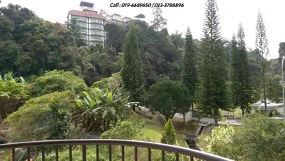 a view of a park with trees and a building at Ar Rayyan Apartments Prima Villa in Tanah Rata