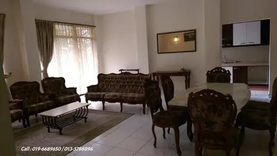 a living room with a table and chairs at Ar Rayyan Apartments Prima Villa in Tanah Rata
