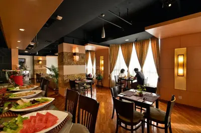 a restaurant with tables and people sitting at tables at Pearl View Hotel Prai, Penang in Perai