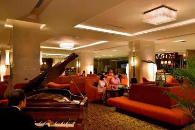 a lobby with a piano and people sitting in chairs at Pearl View Hotel Prai, Penang in Perai