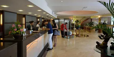 a group of people standing at a counter in a lobby at Pearl View Hotel Prai, Penang in Perai